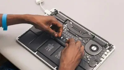 Technician repairing a laptop